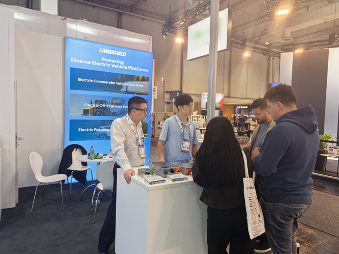 Landworld team discussing EV power products with visitors at IAA TRANSPORTATION 2026